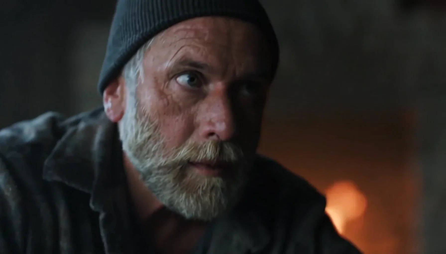 Emotive close-up portrait of an elderly man in a beanie.